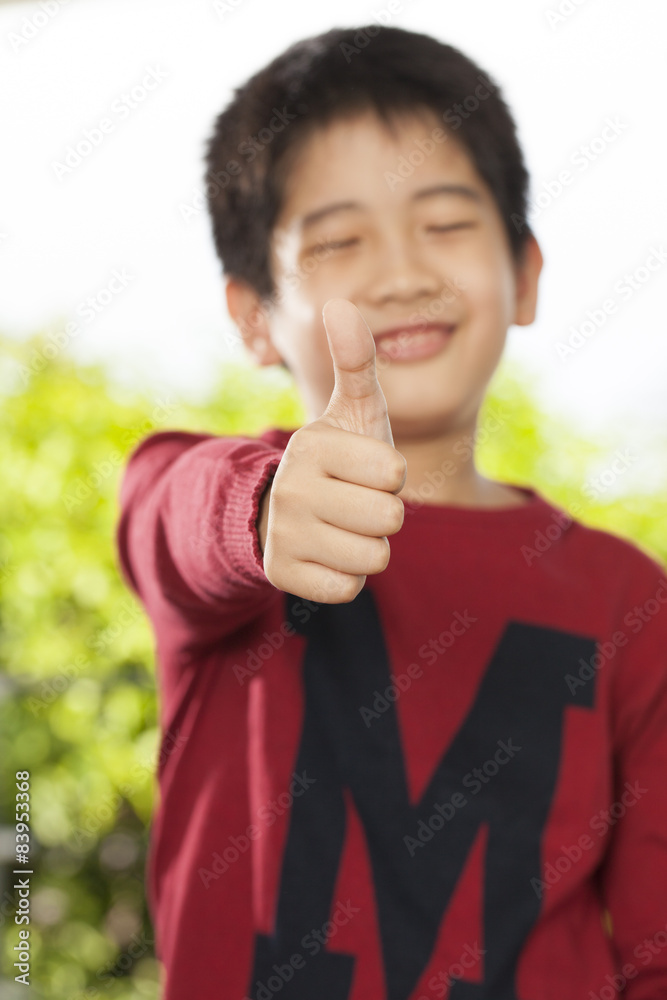 an Asian young boy pose showing expression smiling funny an Asian young boy pose showing expression smiling funny