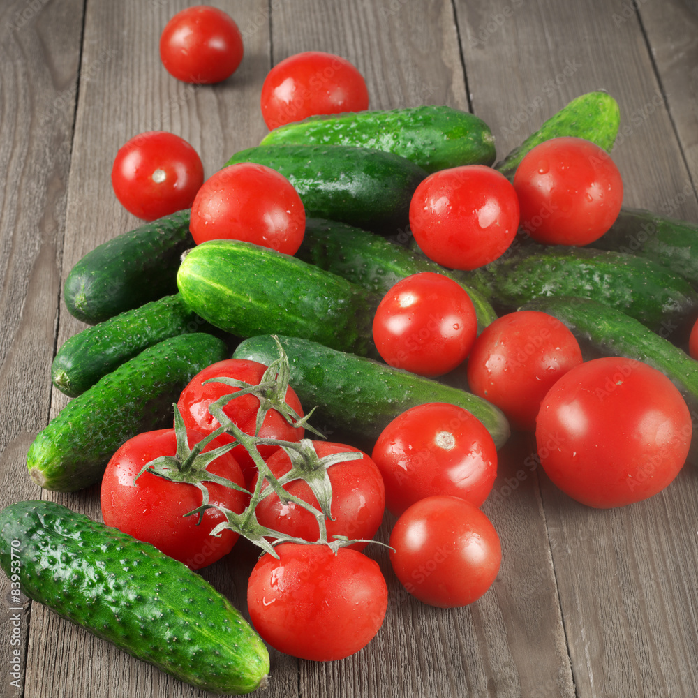 Tomatoes and cucumbers on wood