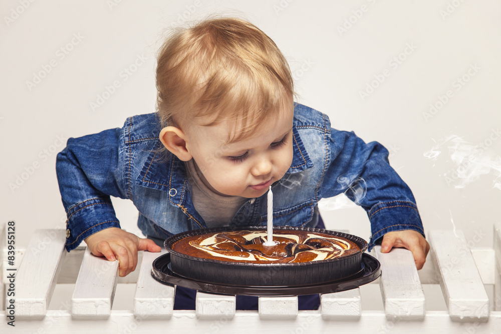 Little baby girl with a cake and a candle Little baby girl with a cake and a candle