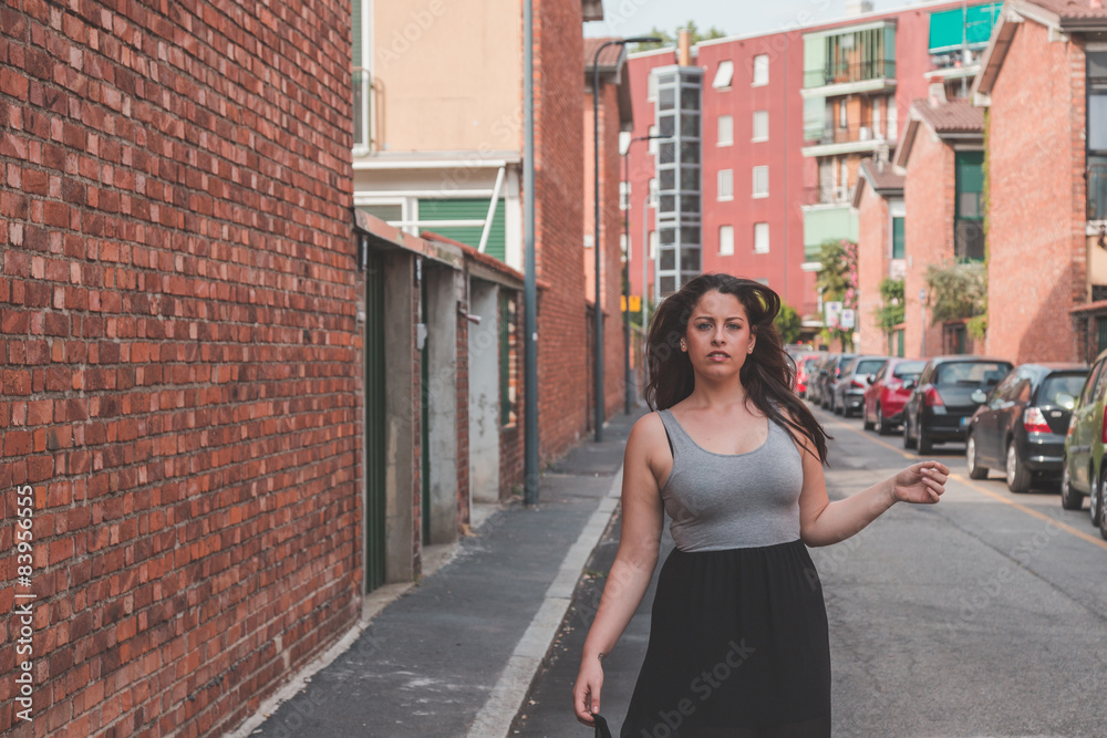 Beautiful curvy girl posing in an urban context