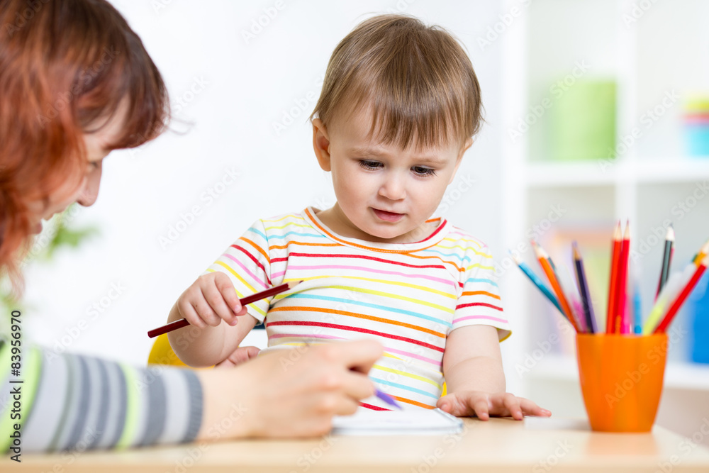 Cute little preschooler child drawing at house Cute little preschooler child drawing at house