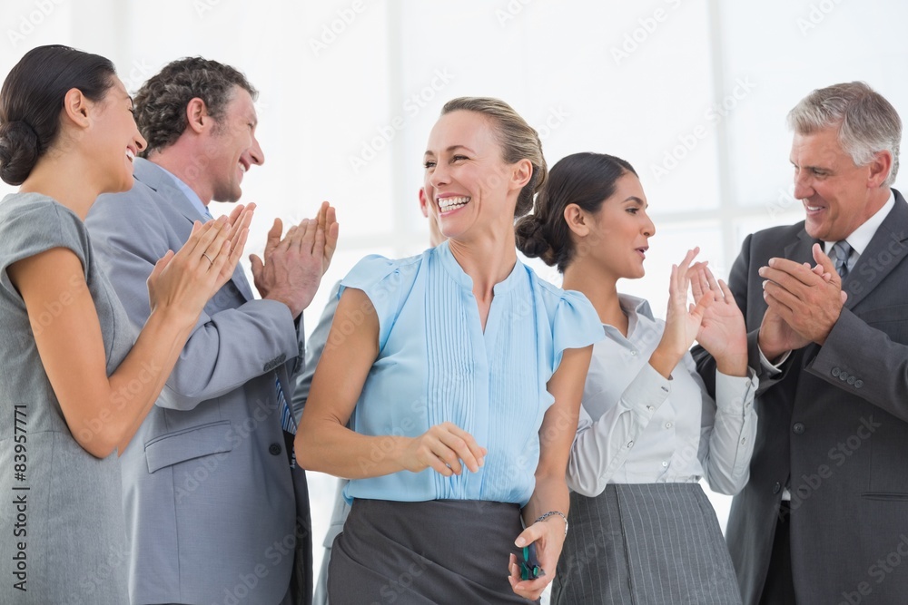 Happy business team smiling at each other 