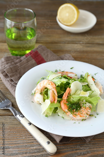 Fresh salad with shrimps, lettuce and cheese on a plate
