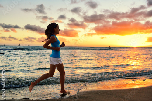 Woman running and jogging training beach sunrise