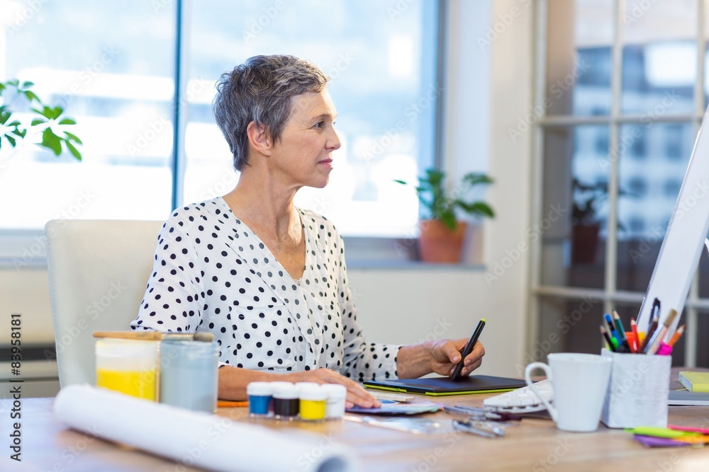 Casual businesswoman drawing with digitizer