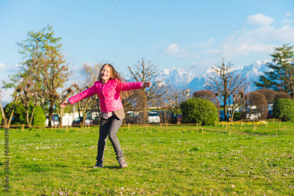 Cute little girl having fun in the park 