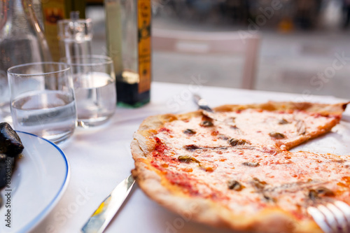 Italian pizza with seafood on the restaurant table