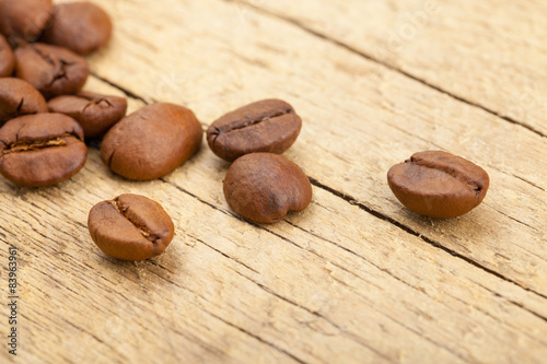 Coffee beans on old wooden table - close up studio shot