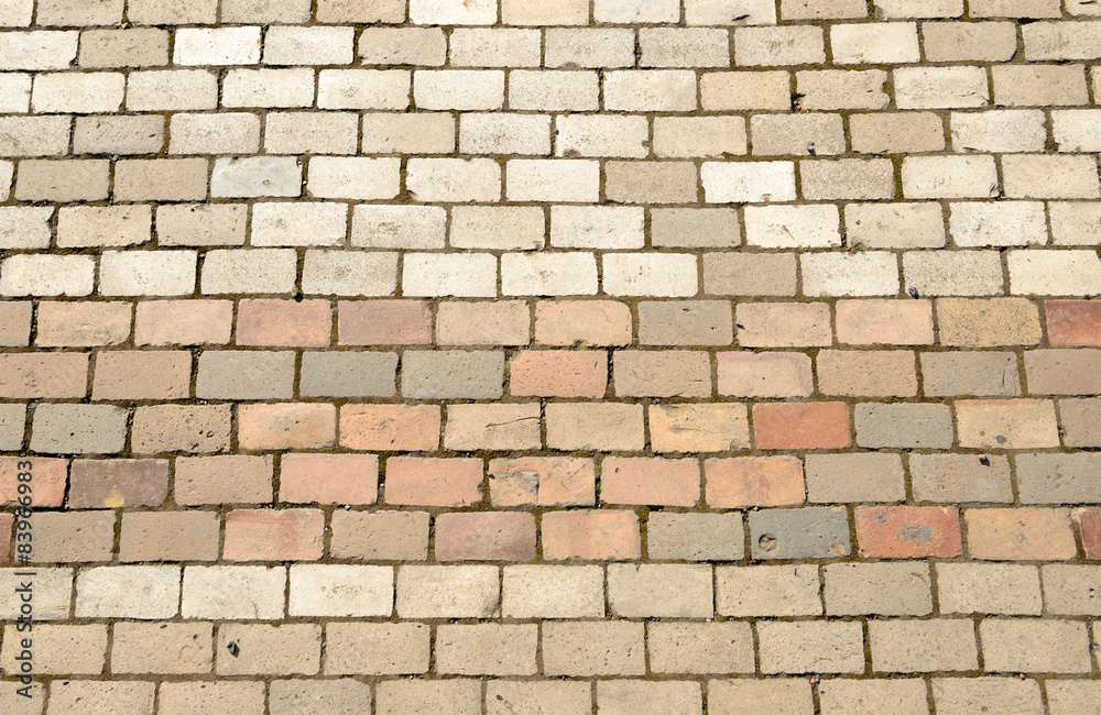 Fototapeta premium Pavement bricks of beige and pinkish colors as background.