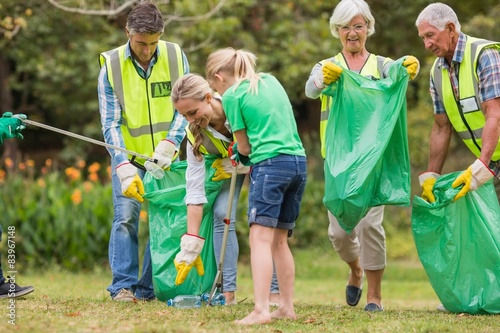 Happy family collecting rubbish 