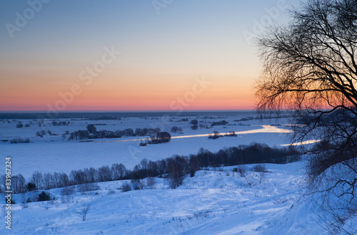 Sunrise over the river in winter