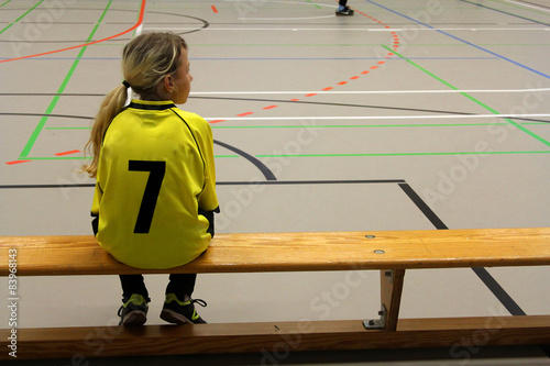Girl soccer player on the bench