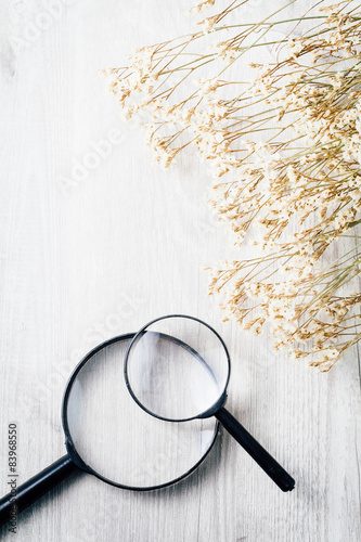 Discovery search symbol, Magnifying glass on wooden table