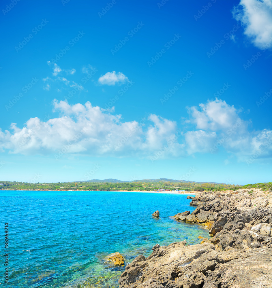 rocky shore with Lazzaretto beach in the background