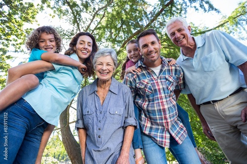 Extended family smiling in the park