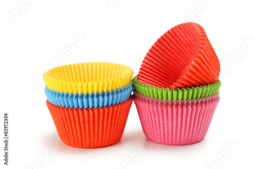 Empty colorful cupcake cases isolated on white