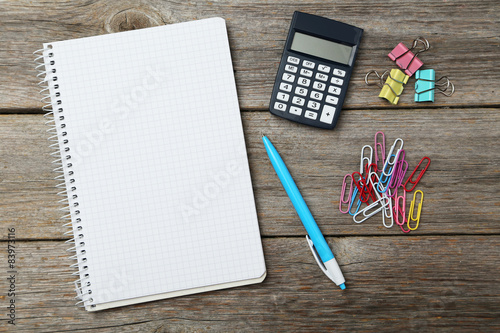 Office supplies on grey wooden background