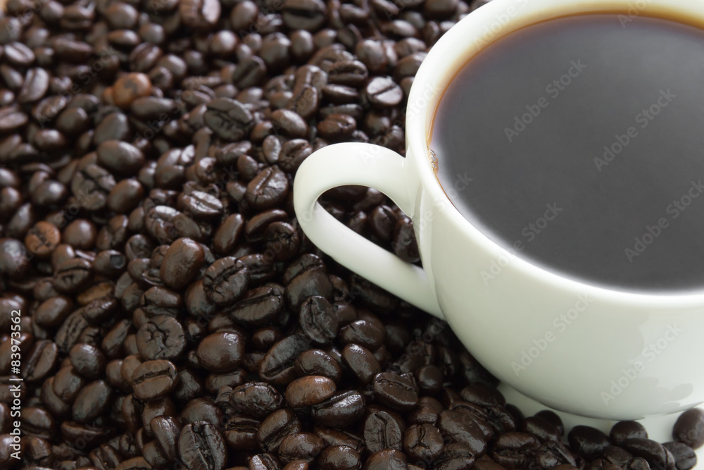 Coffee cup with beans on wood table Coffee cup with beans on wood table