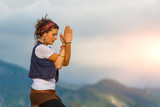 Girl practicing yoga in nature in the mountains