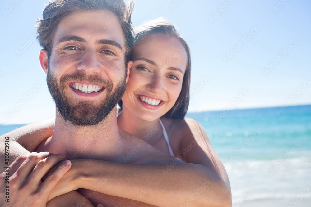Happy couple hugging and looking at camera Happy couple hugging and looking at camera