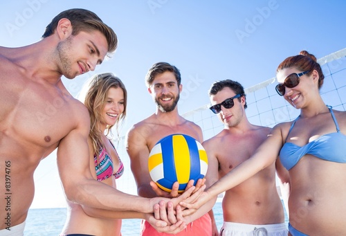 Group of friends holding volleyball © WavebreakmediaMicro