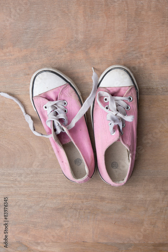 Close up of pink sneakers worn by a teenager 