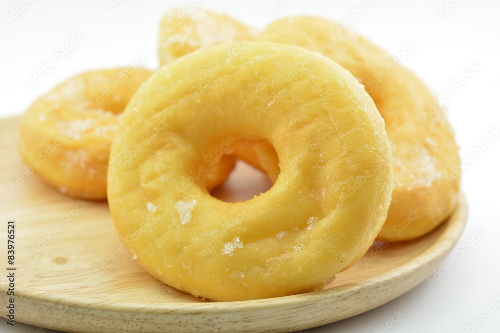 Sugary donuts on wood plates Sugary donuts on wood plates