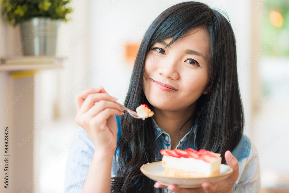 Portrait of young asian pretty smiling woman eating cake at cafe Portrait of young asian pretty smiling woman eating cake at cafe
