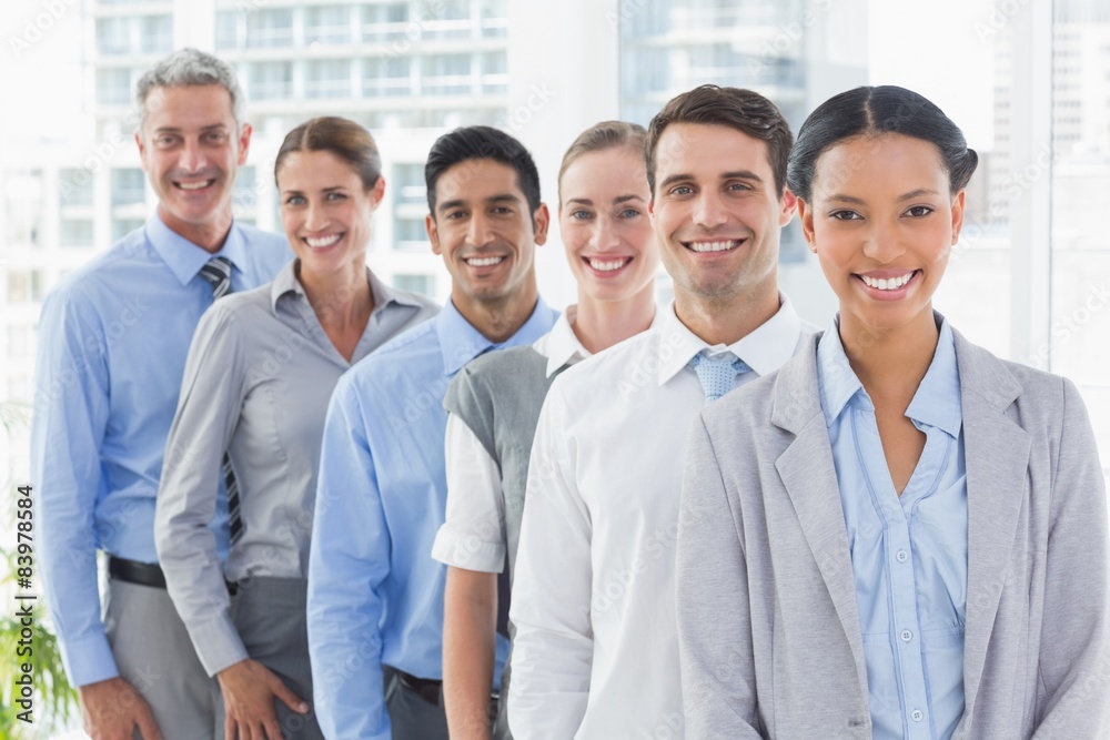 Happy business people looking at camera in a row Happy business people looking at camera in a row