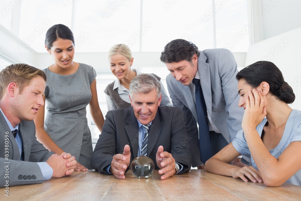 Fototapeta premium Businessman forecasting the future with his crystal ball