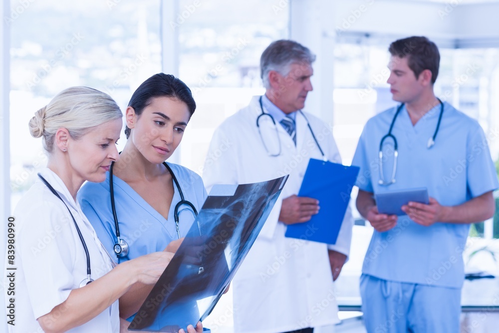 Team of smiling doctors discussing Team of smiling doctors discussing