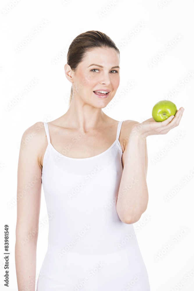 young woman holding an apple and looking at camera. young woman holding an apple and looking at camera.