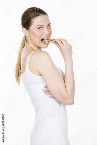 woman with white dress holding a healthy fruit bar
