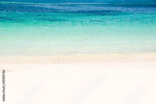 Edge of a beach with turquoise water and white sand