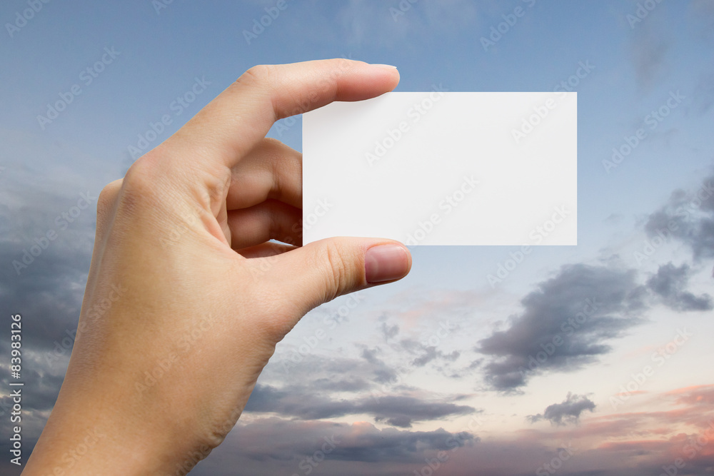 Hands holding a white business visit card, gift, ticket, pass, p Hands holding a white business visit card, gift, ticket, pass, p