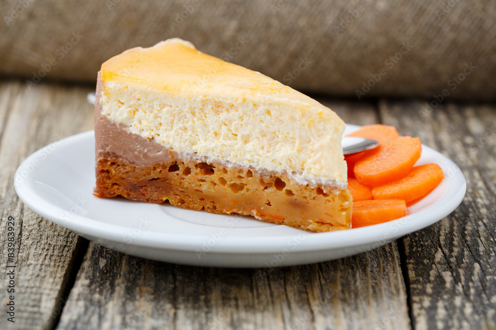 Sweet slice of carrot cake on white plate.