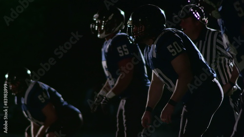 Football defensive players line up and get ready for the next play 