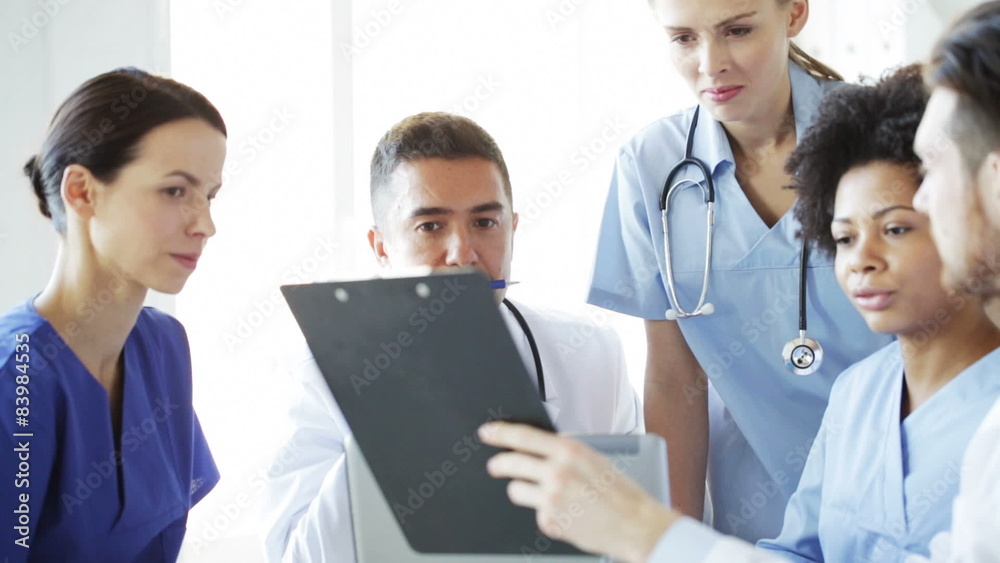 group of doctors with clipboard talking at clinic group of doctors with clipboard talking at clinic