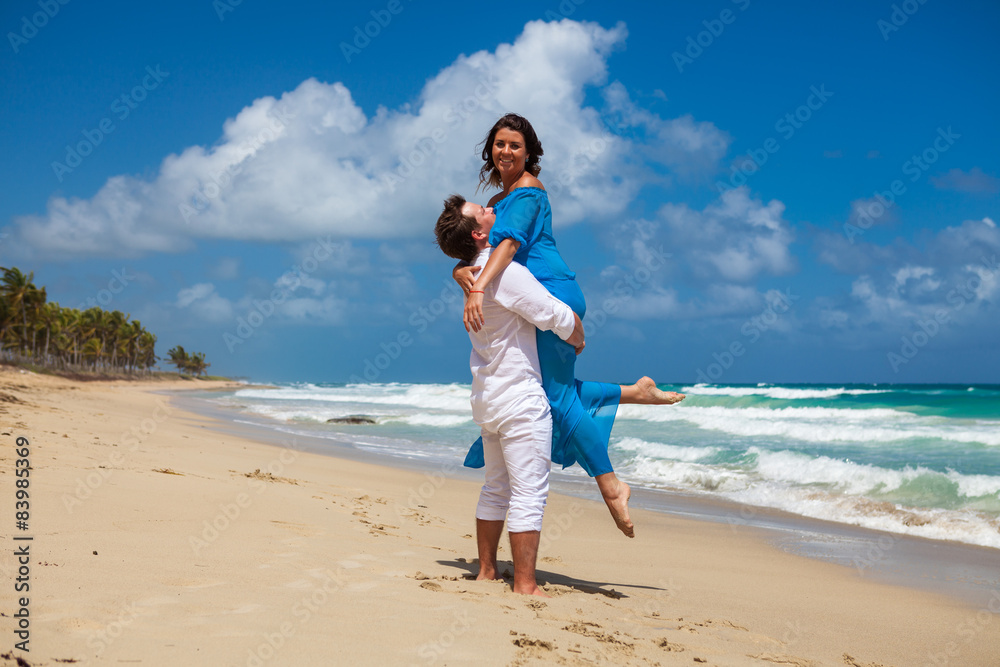 Beach couple walking on romantic travel.