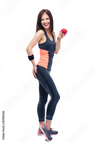 Happy fitness woman holding apple