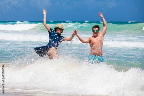 Couple have a fun in ocean's waves