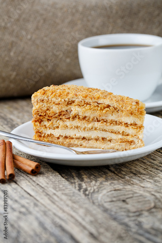 Tasty honey cake on wooden background.