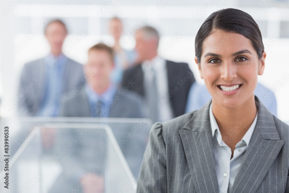 Smiling businesswoman looking at camera during conference Smiling businesswoman looking at camera during conference