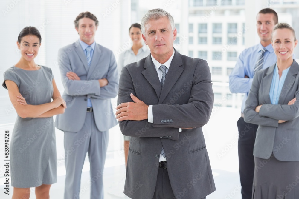 Smiling business team standing with arms crossed Smiling business team standing with arms crossed