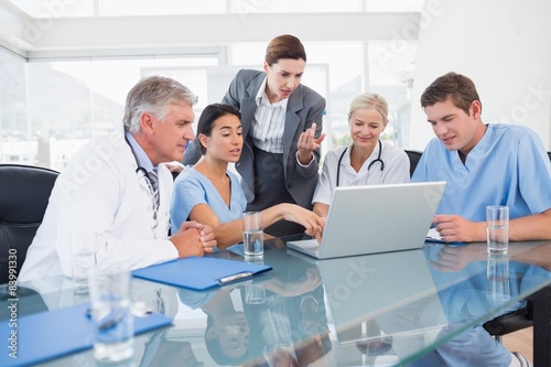 Team of doctors and businesswoman having a meeting