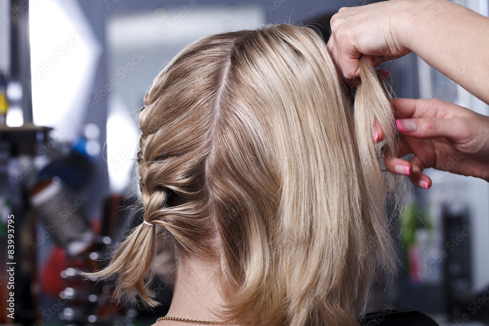 Naklejka premium The master the hairdresser does a hairdress