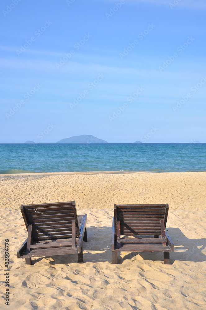 Beach chairs on sand beach. 
