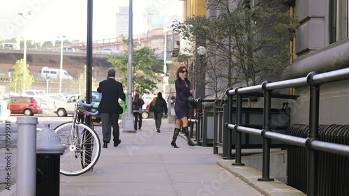 Wallpaper Mural Two business people walk down the sidewalk while talking on their cell phone Torontodigital.ca