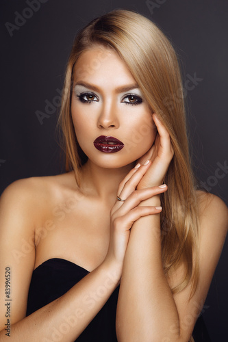 High Fashion Photo of a Woman. Red Lips and Metallic Shadows