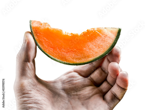 piece of juicy  melon holds men's hand isolated on white backgro